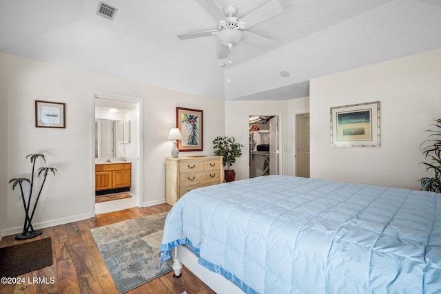 bedroom featuring ensuite bathroom, wood-type flooring, a walk in closet, ceiling fan, and a closet