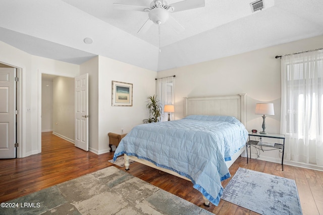 bedroom with vaulted ceiling, hardwood / wood-style floors, and ceiling fan