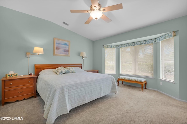 carpeted bedroom featuring ceiling fan, vaulted ceiling, and visible vents