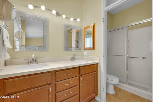 bathroom featuring toilet, a shower stall, and a sink