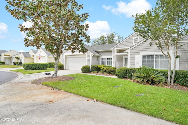 view of front facade featuring a garage, driveway, and a front lawn