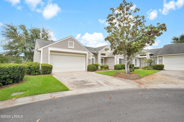 multi unit property featuring a garage, a front lawn, and concrete driveway