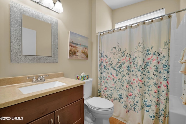 full bath with vanity, shower / bath combo, and toilet
