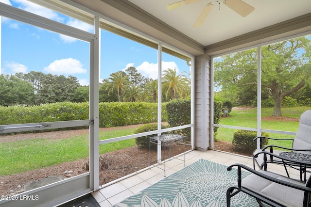 sunroom featuring a ceiling fan and plenty of natural light