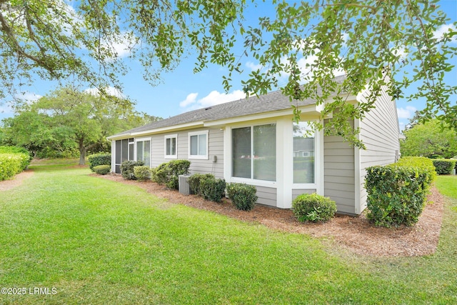 rear view of house featuring a yard