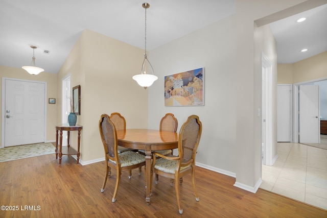 dining area featuring baseboards, recessed lighting, and wood finished floors