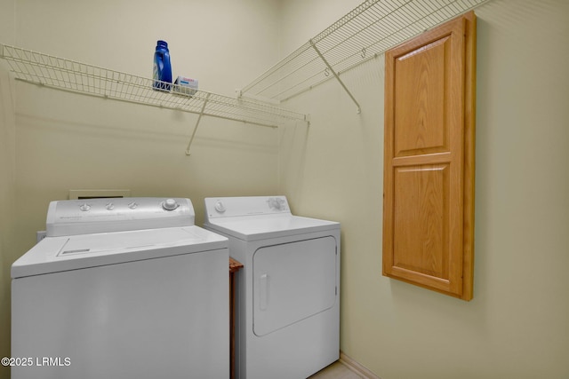 laundry room with separate washer and dryer and cabinet space