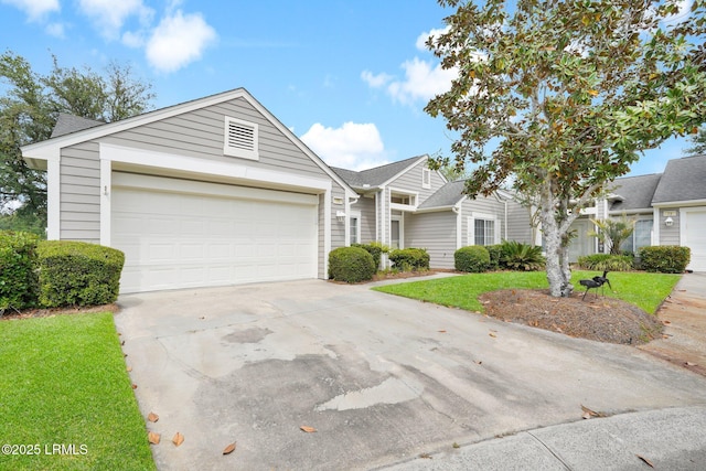 view of front of property featuring a garage, a front lawn, and concrete driveway