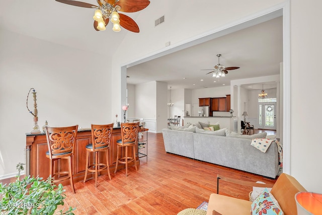 128 Colvin Dr, Okatie, SC 29909 - interior space featuring light wood-style floors, ceiling fan with notable chandelier, lofted ceiling, and visible vents