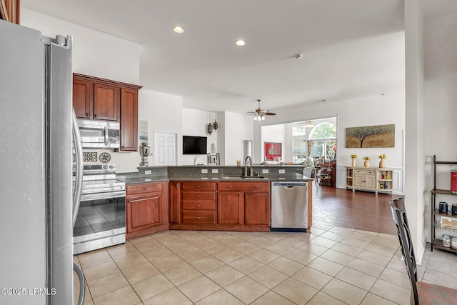 128 Colvin Dr, Okatie, SC 29909 - kitchen with light tile patterned floors, a sink, open floor plan, a ceiling fan, and stainless steel appliances