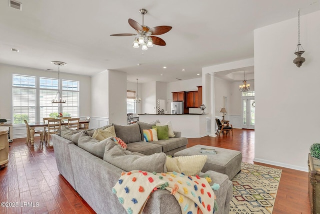 128 Colvin Dr, Okatie, SC 29909 - living room with visible vents, a wealth of natural light, dark wood-style floors, and ceiling fan with notable chandelier