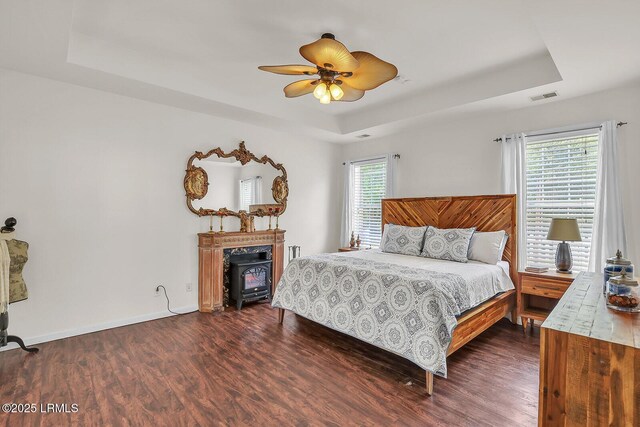 128 Colvin Dr, Okatie, SC 29909 - bedroom with visible vents, a tray ceiling, baseboards, and dark wood-style floors