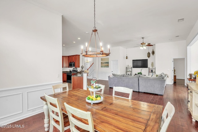 128 Colvin Dr, Okatie, SC 29909 - dining room featuring ceiling fan with notable chandelier, dark wood-style flooring, visible vents, and a decorative wall