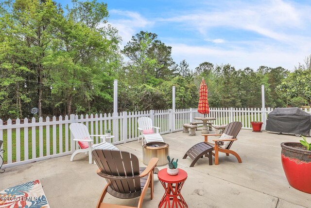 128 Colvin Dr, Okatie, SC 29909 - view of patio with area for grilling, fence, and an outdoor fire pit