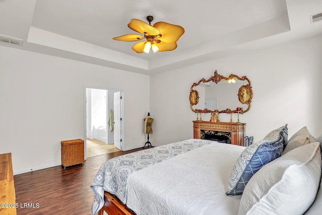 128 Colvin Dr, Okatie, SC 29909 - bedroom with visible vents, a raised ceiling, and wood finished floors