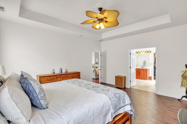 128 Colvin Dr, Okatie, SC 29909 - bedroom with visible vents, baseboards, a raised ceiling, and wood finished floors