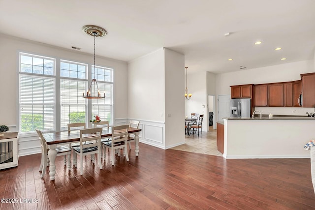 128 Colvin Dr, Okatie, SC 29909 - dining space with a chandelier, a decorative wall, visible vents, and wood finished floors