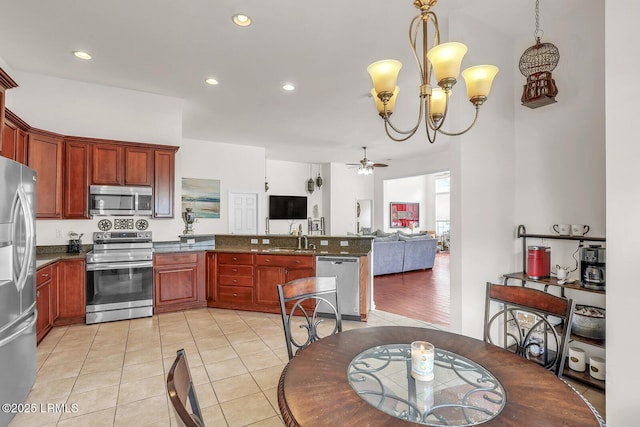 128 Colvin Dr, Okatie, SC 29909 - kitchen featuring a sink, open floor plan, appliances with stainless steel finishes, a peninsula, and ceiling fan with notable chandelier