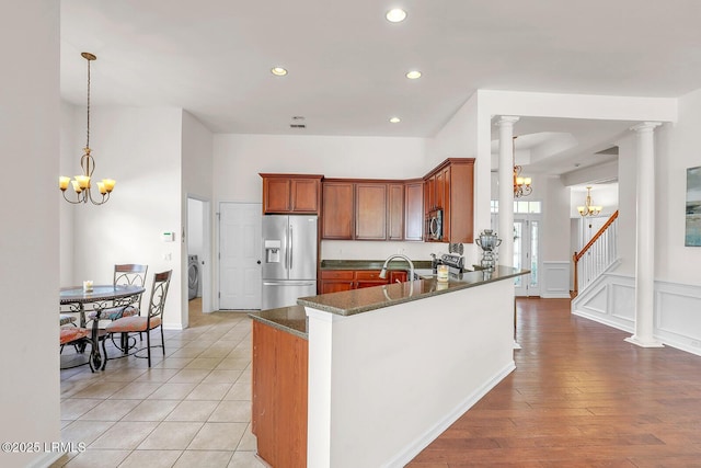 128 Colvin Dr, Okatie, SC 29909 - kitchen with washer / clothes dryer, a notable chandelier, appliances with stainless steel finishes, decorative columns, and a decorative wall