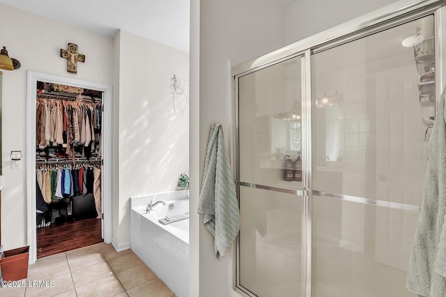 128 Colvin Dr, Okatie, SC 29909 - full bathroom featuring a garden tub, tile patterned flooring, a walk in closet, a stall shower, and baseboards