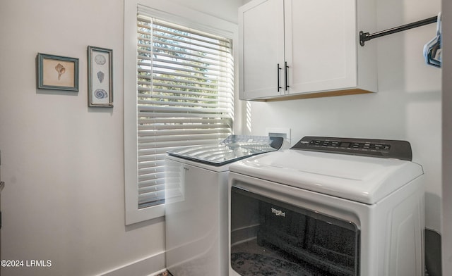 washroom featuring cabinets and washer and dryer