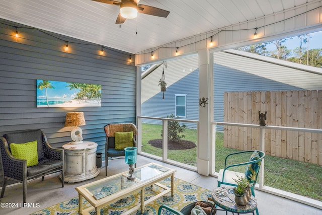 sunroom / solarium featuring ceiling fan