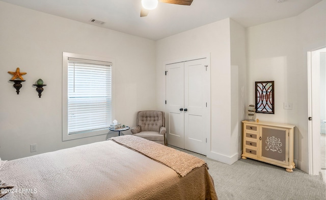 carpeted bedroom featuring a closet and ceiling fan