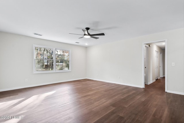 unfurnished room featuring ceiling fan and dark hardwood / wood-style flooring