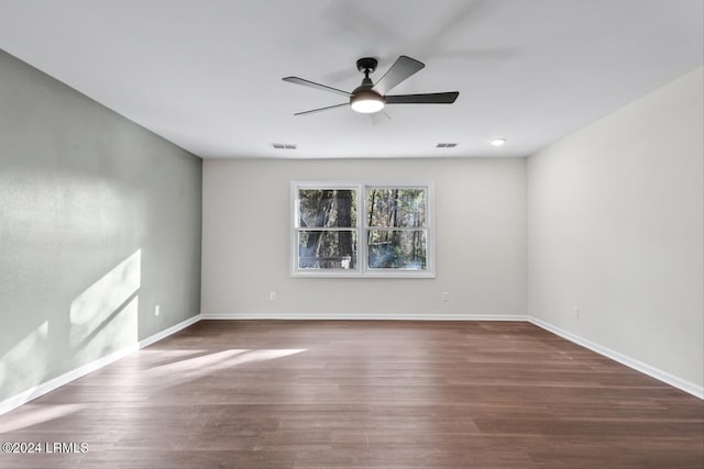 spare room with dark hardwood / wood-style floors and ceiling fan