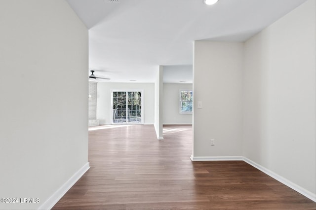 corridor with hardwood / wood-style floors