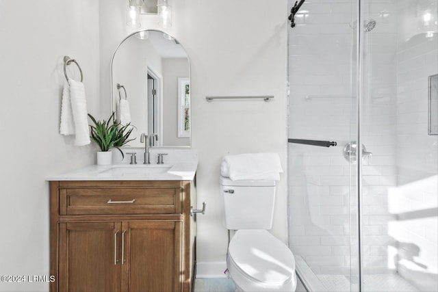 bathroom featuring vanity, an enclosed shower, and toilet