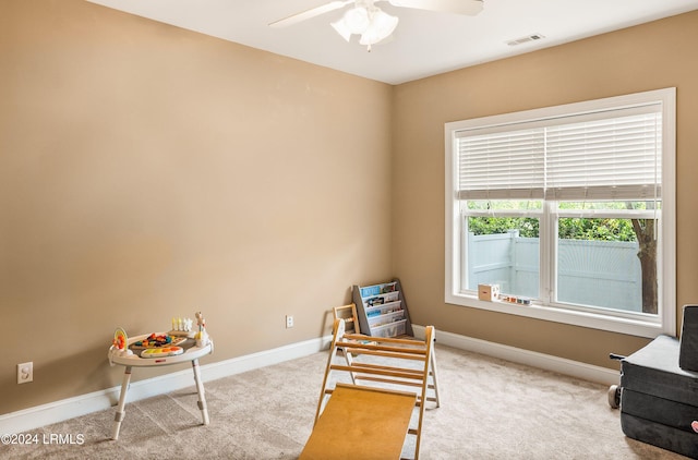 sitting room with light carpet and ceiling fan