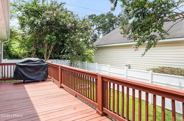 wooden terrace with a grill