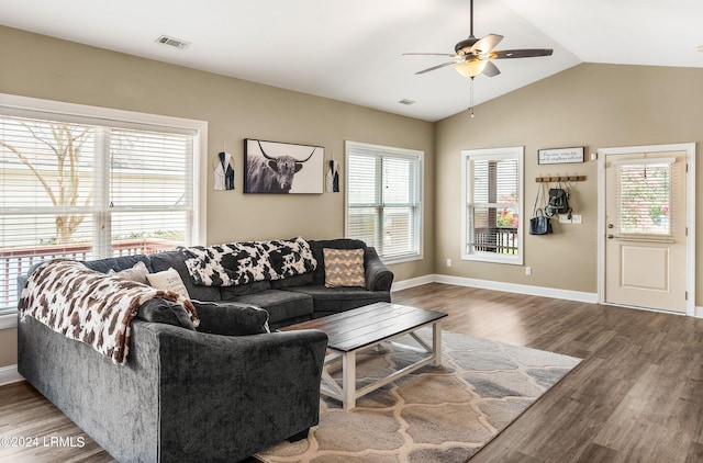 living room with ceiling fan, wood-type flooring, vaulted ceiling, and a wealth of natural light