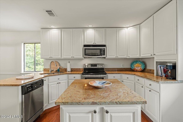 kitchen featuring appliances with stainless steel finishes, sink, and white cabinets