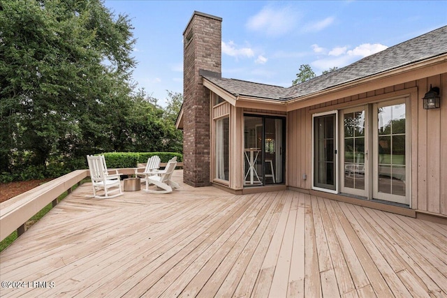 wooden deck with a fire pit