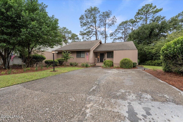 ranch-style home with a front lawn