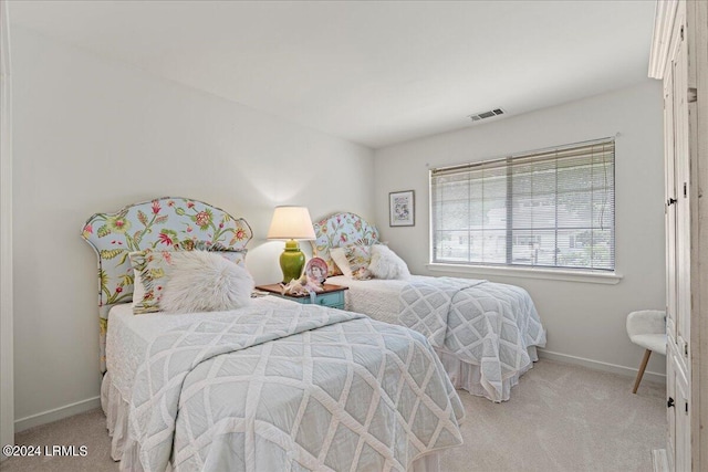 bedroom featuring light colored carpet