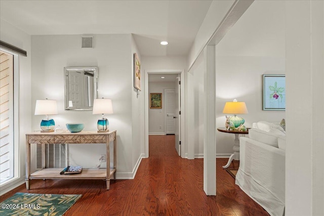 hallway with hardwood / wood-style floors