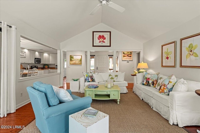 living room with vaulted ceiling, wood-type flooring, and ceiling fan