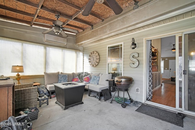 sunroom / solarium featuring ceiling fan and a wall mounted AC