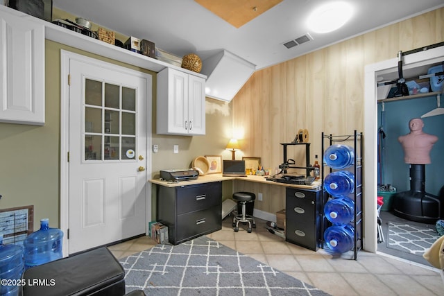 office space featuring light tile patterned floors and wood walls