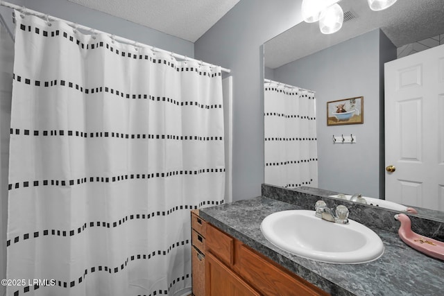 bathroom with vanity and a textured ceiling