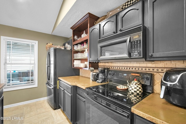 kitchen with decorative backsplash and black appliances