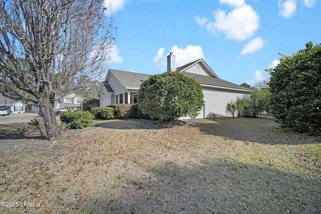 view of side of home featuring a yard