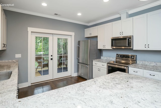 kitchen featuring light stone countertops, dark wood finished floors, ornamental molding, stainless steel appliances, and white cabinets