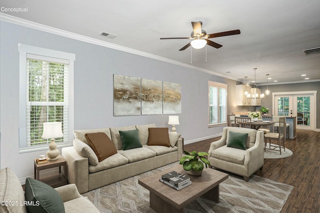 living area featuring visible vents, dark wood-type flooring, and crown molding