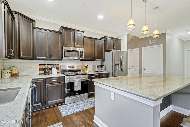 296 Hulston Landing Rd, Bluffton, SC 29909 - kitchen with appliances with stainless steel finishes, crown molding, dark brown cabinets, backsplash, and a kitchen island