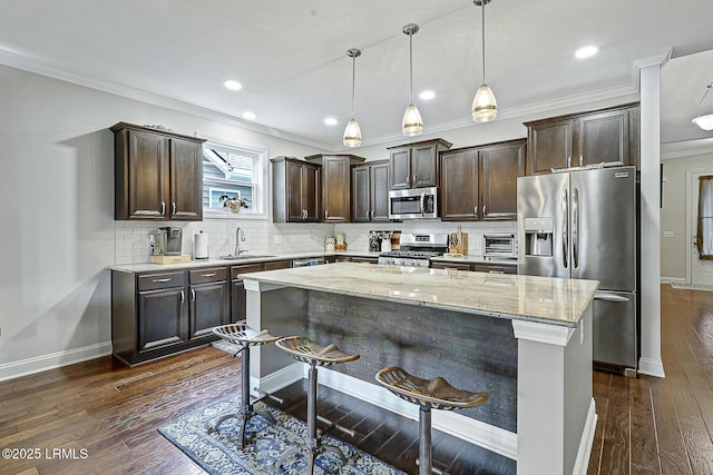 296 Hulston Landing Rd, Bluffton, SC 29909 - kitchen featuring appliances with stainless steel finishes, dark brown cabinets, dark wood-style floors, ornamental molding, and light stone counters