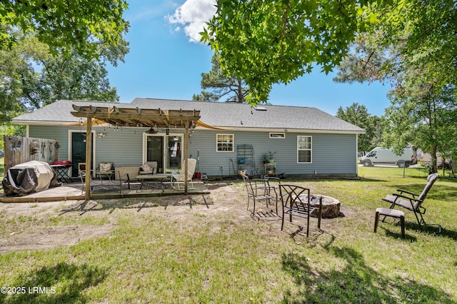 6 Wegeon Ln, Beaufort, SC 29906 - rear view of house featuring a pergola, an outdoor fire pit, a yard, a patio, and roof with shingles